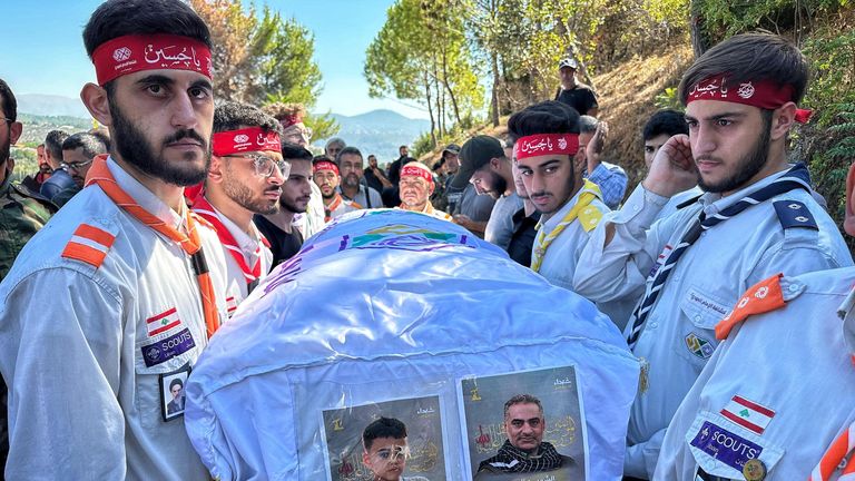 The coffin of a young boy is carried